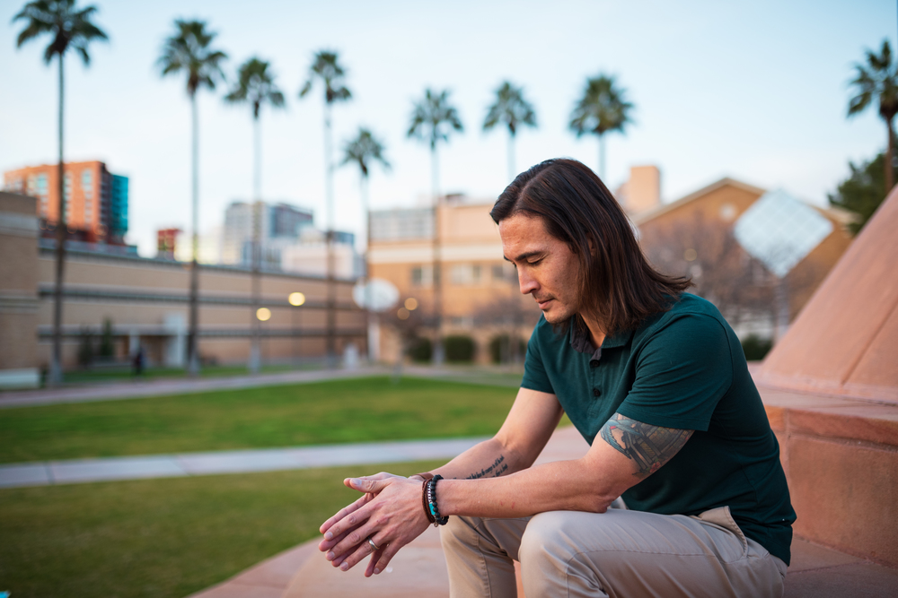 ASU faculty member takes a mindfulness moment on Tempe campus to pause and meditate.