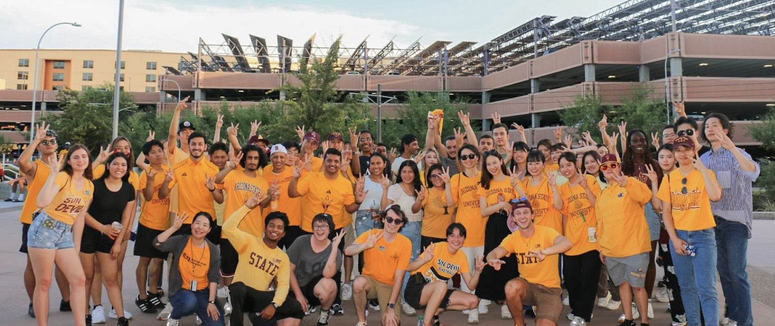 Group of Global Launch students posing for a photo before attending an Arizona State University football game on Tempe campus.