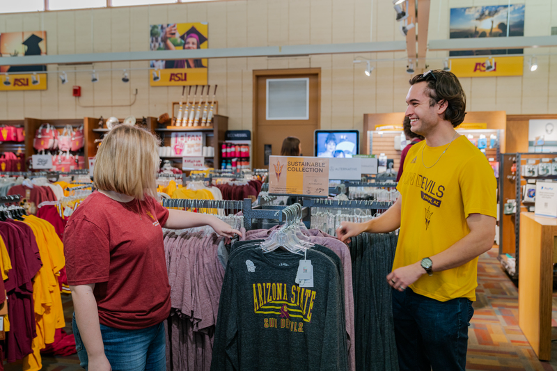 Two students admire ASU clothing in the ASU Campus Store.