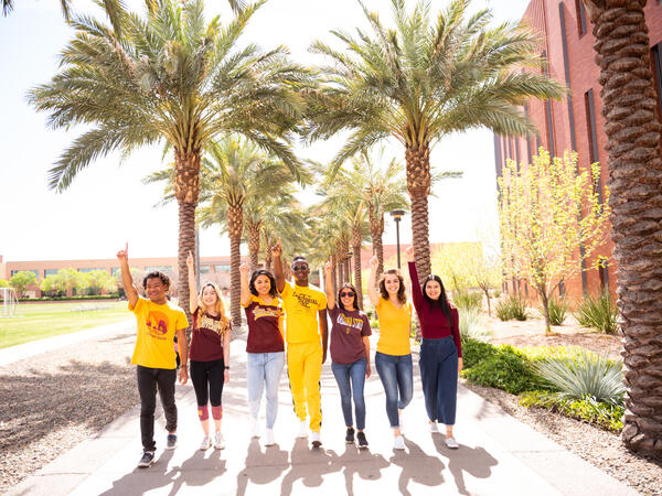 A group of ASU students walking down palm walk on Tempe campus.