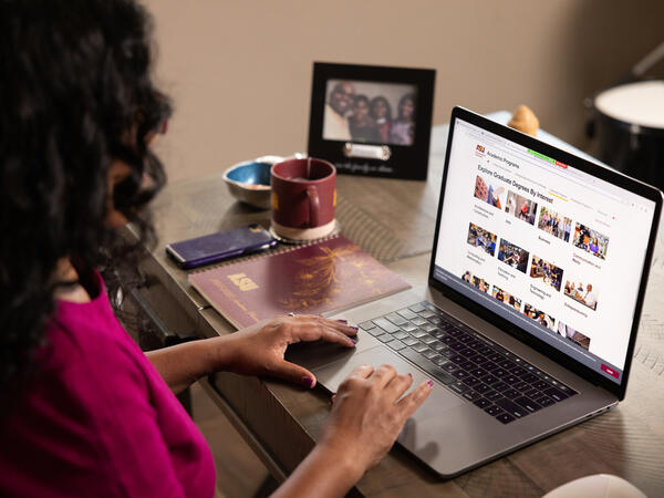 ASU student exploring graduate degree programs on her laptop at home.