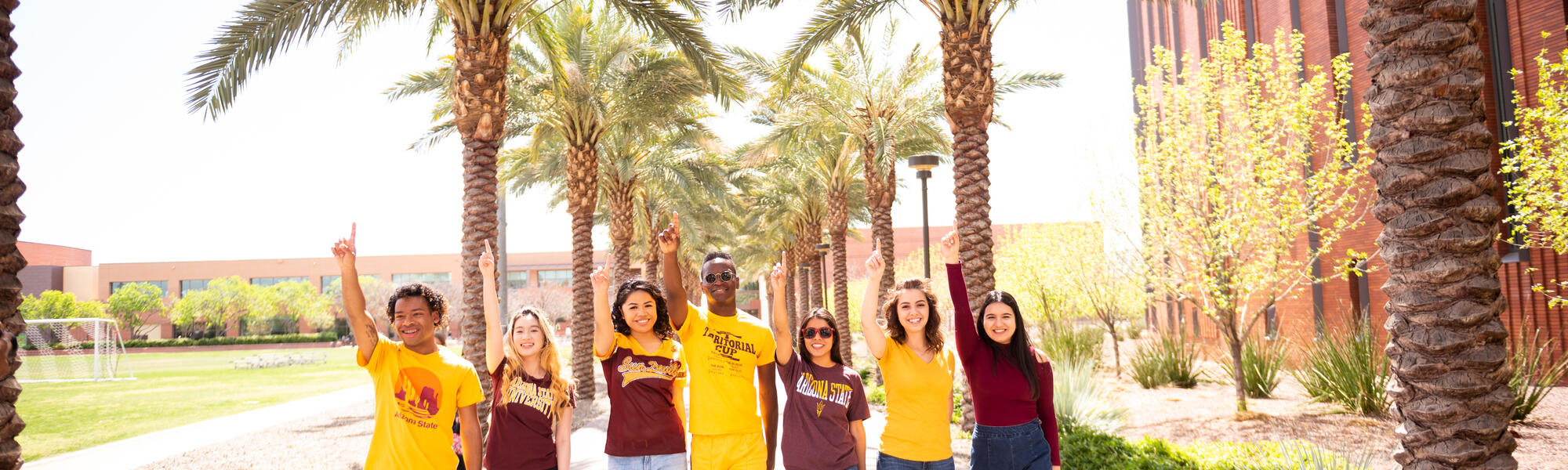 A group of ASU students walking down palm walk on Tempe campus.