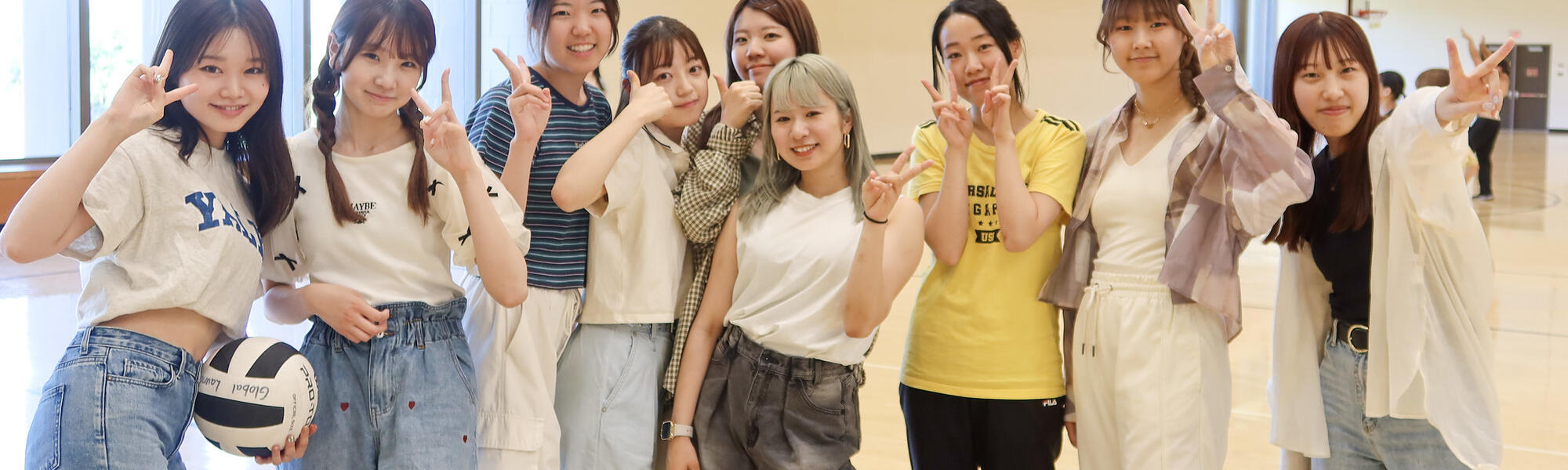 A group of students posing for a photo after playing volleyball.