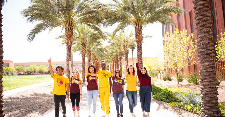 A group of ASU students walking down palm walk on Tempe campus.