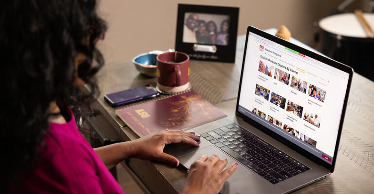 ASU student exploring graduate degree programs on her laptop at home.