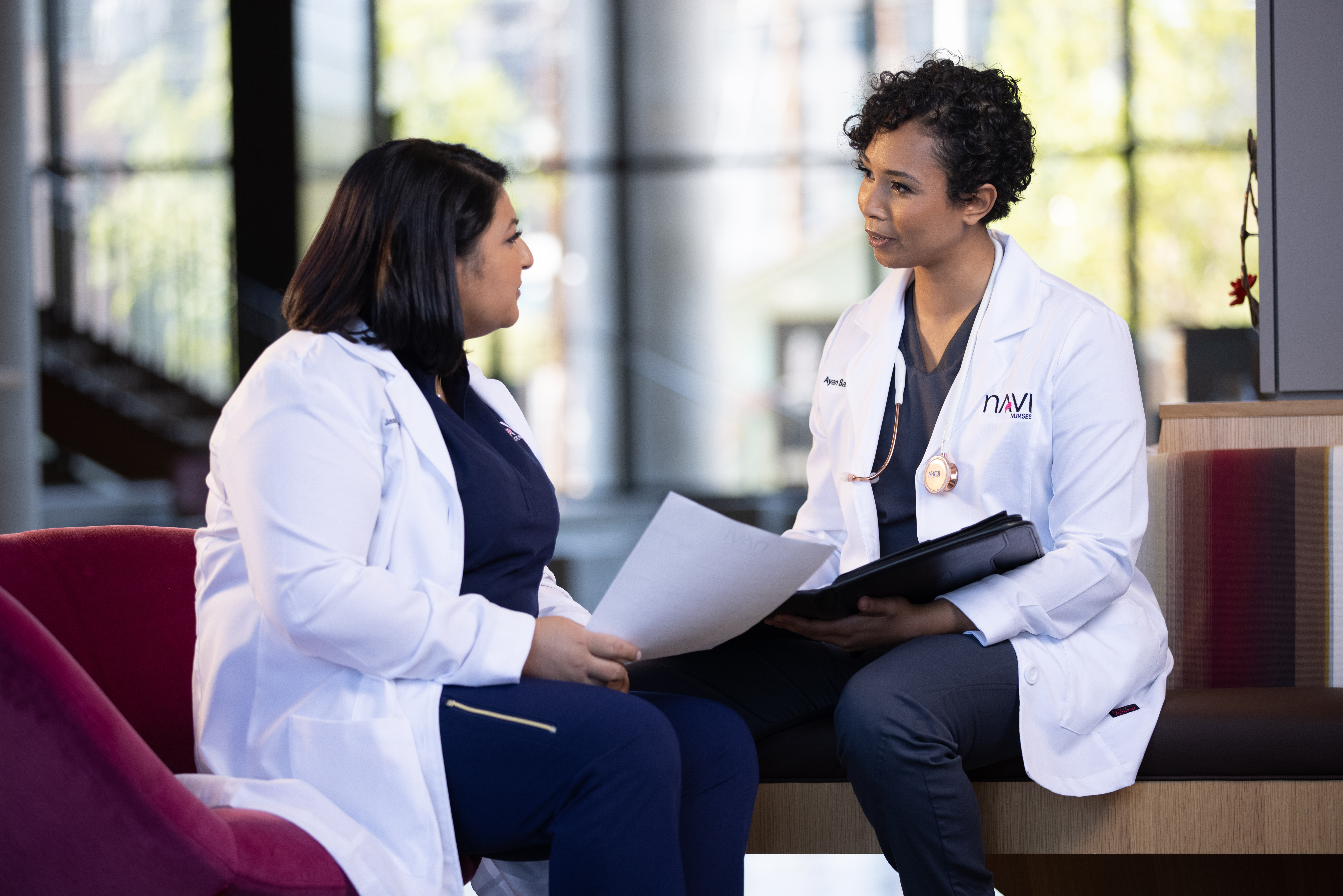 Two medical students discuss notes in an ASU building