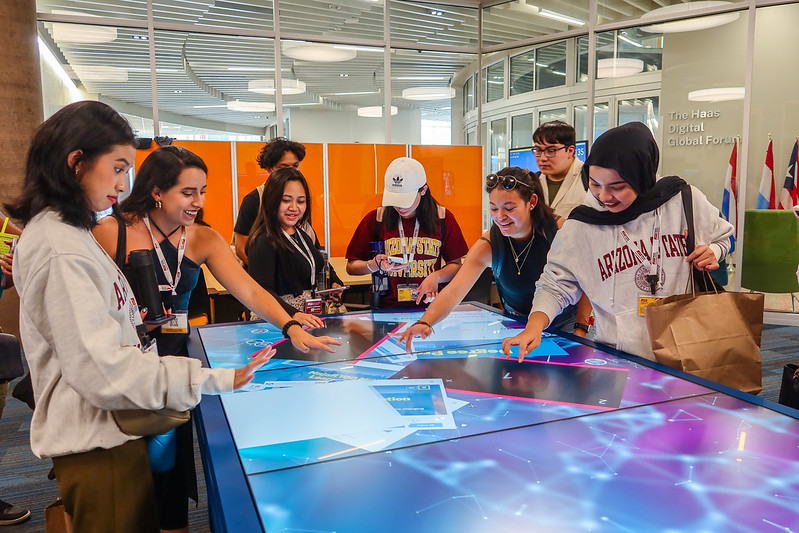 Students engaged with various digital technologies at Thunderbird School of Global Management.