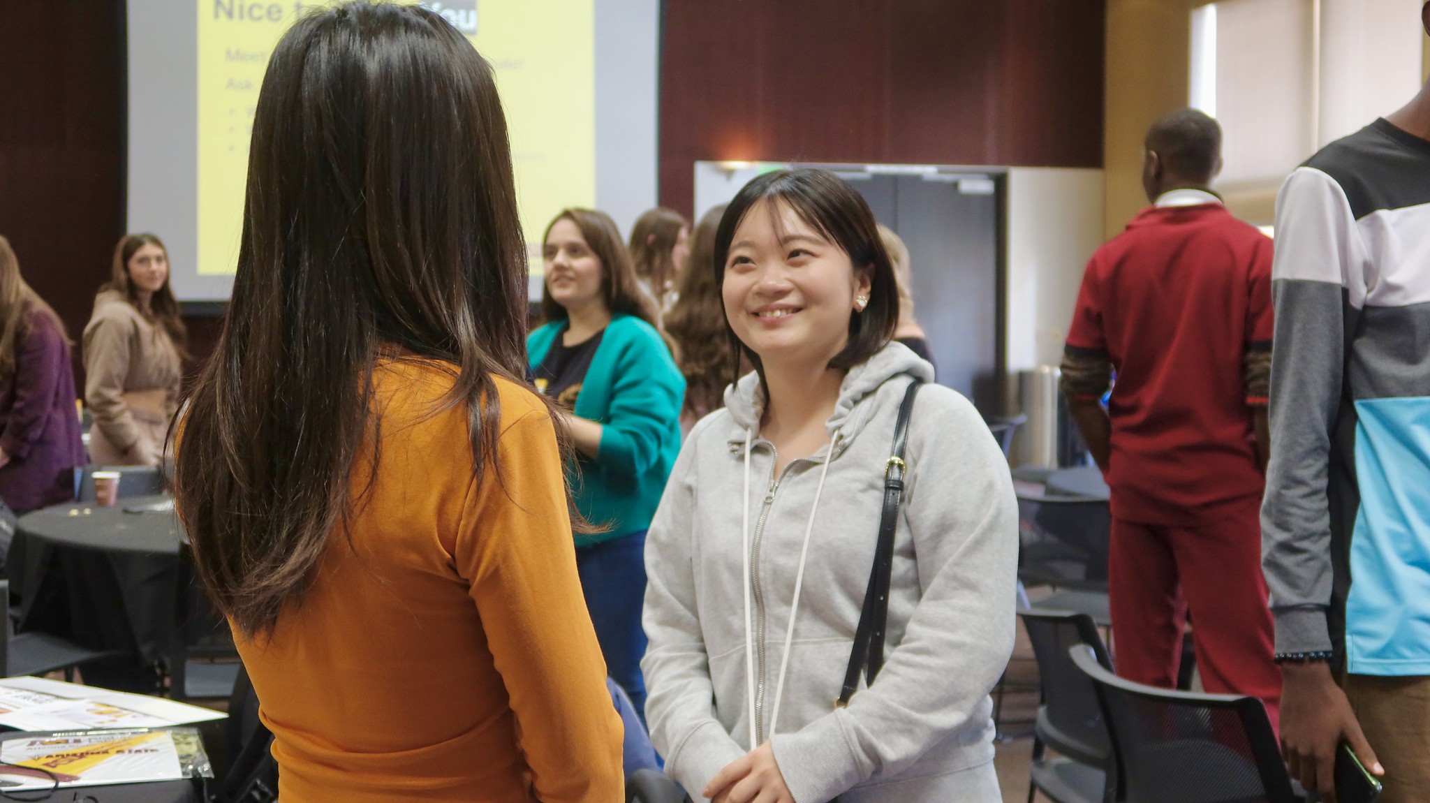 Two Global Launch students chat to get to know each other during orientation lunch.
